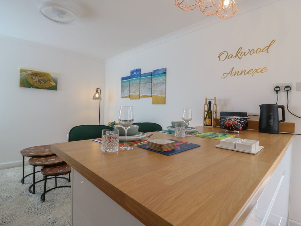 A dining room with table and chairs at Oakwood Annexe in Colchester