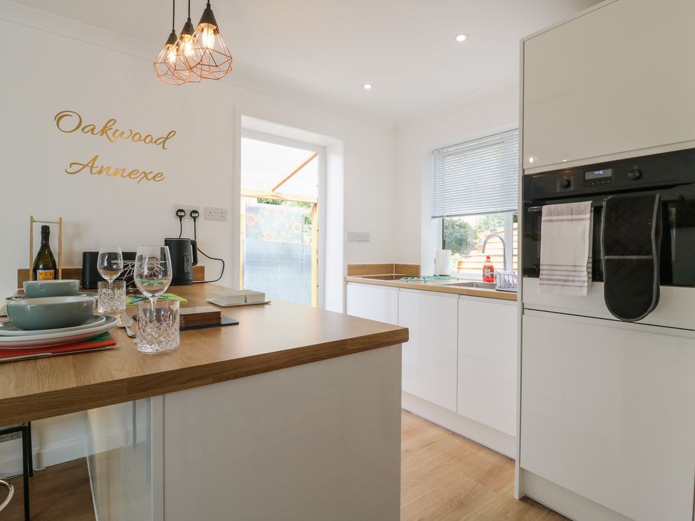 A kitchen with counter and utensils at Oakwood Annexe in Colchester