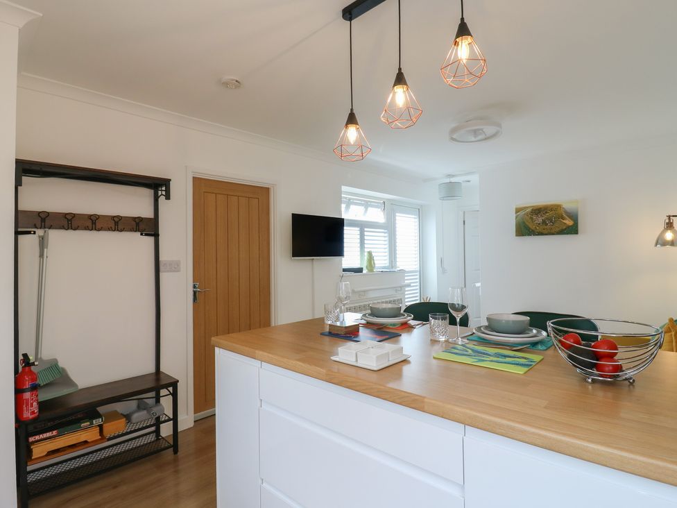 A kitchen with a table and chairs at Oakwood Annexe in Colchester