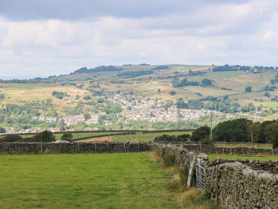 A view of a village in a valley surrounded by hills at Lodge High Peak