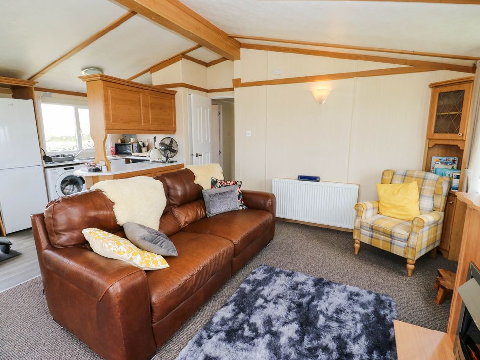A living room with a sofa and chair at Lodge in High Peak