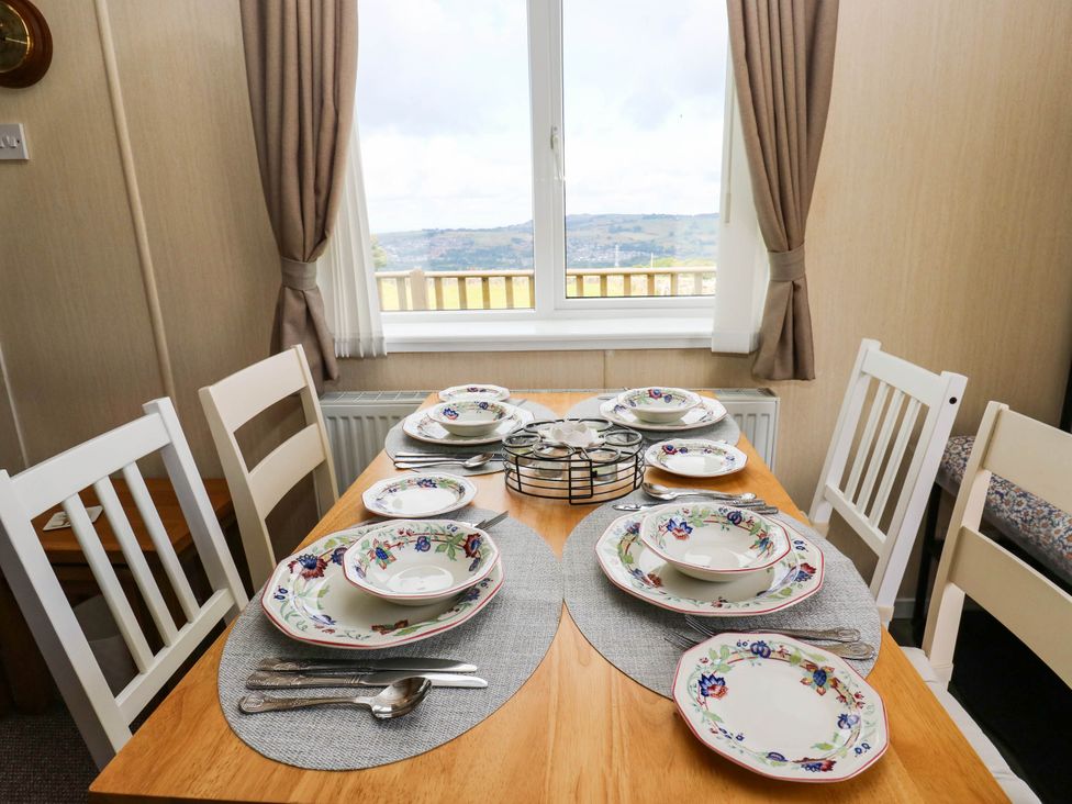 A dining room with a table set for a meal at Lodge in High Peak