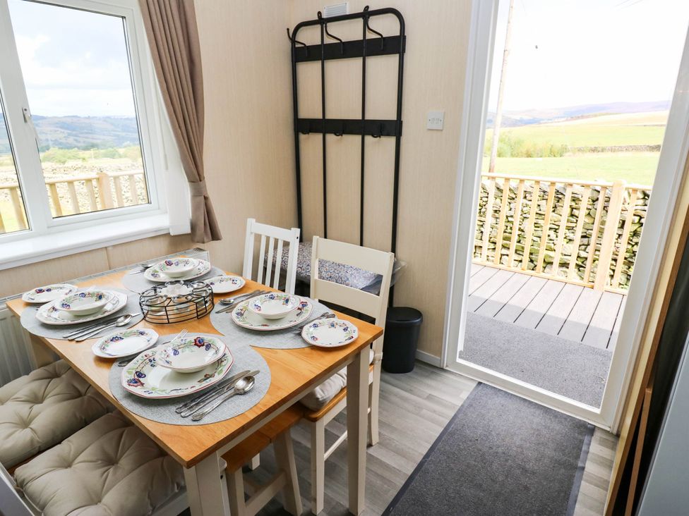 A dining room with a table set for a meal at Lodge in High Peak