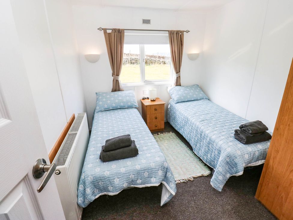 A bedroom with two beds and a nightstand at Lodge High Peak