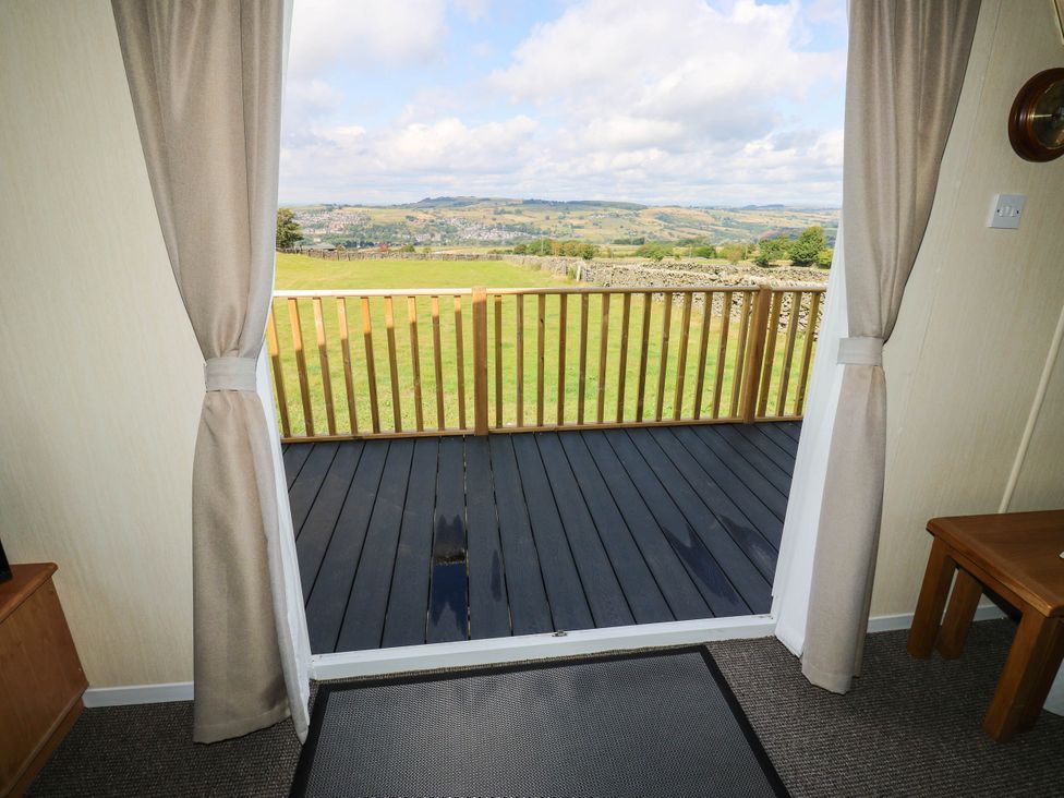 An interior view showing a door leading to a balcony at Lodge in High Peak