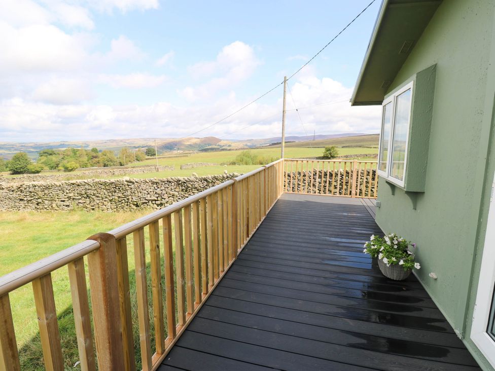 An outdoor deck with a view of fields and hills at Lodge in High Peak