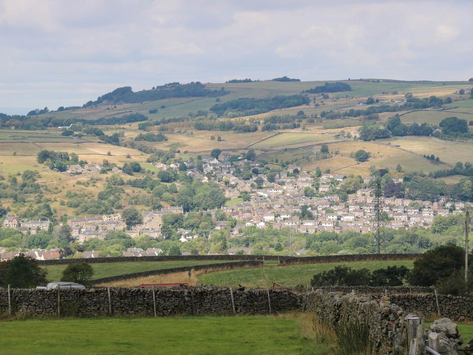 A landscape view of hills and a town at Lodge High Peak
