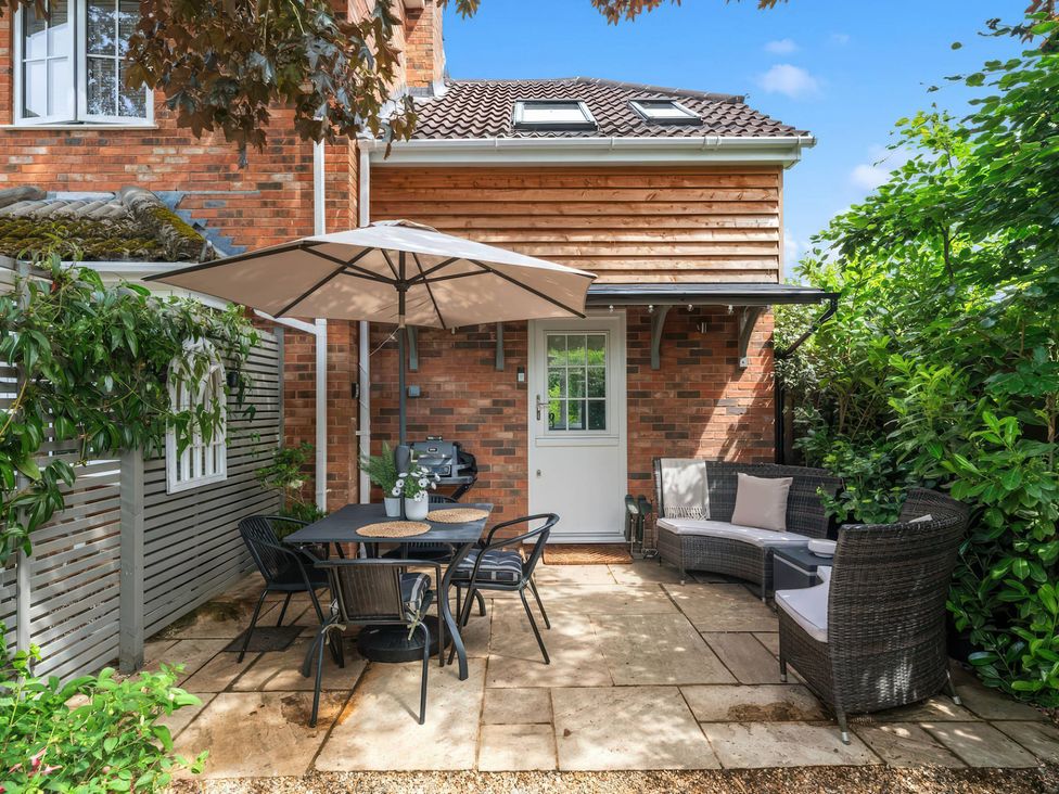 An outdoor patio with a table and chairs at TBC