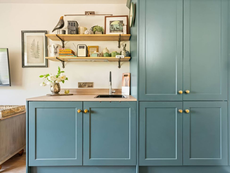 A kitchen with a sink and cabinets at TBC in 