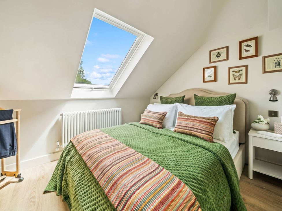 A bedroom with a bed and window at TBC