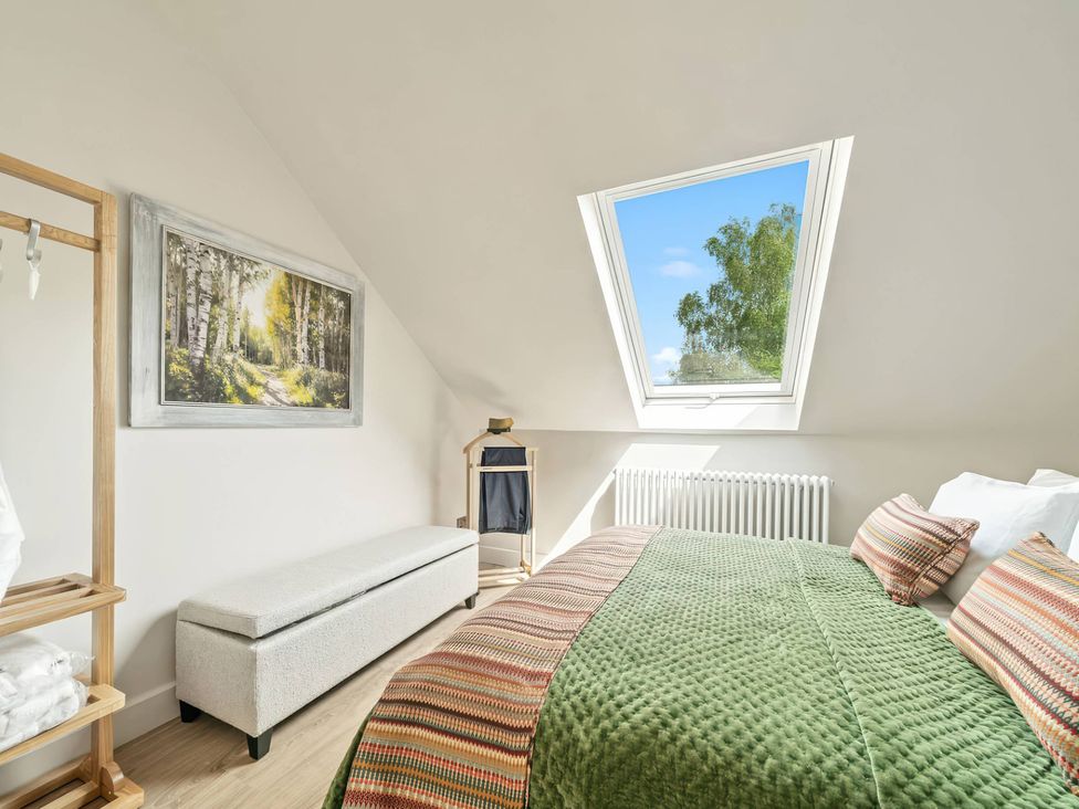 A bedroom with a bed and window at TBC 