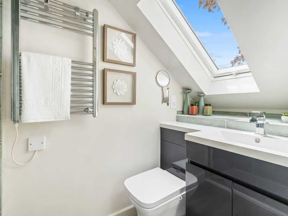 A bathroom with a towel radiator, toilet and sink at TBC in 