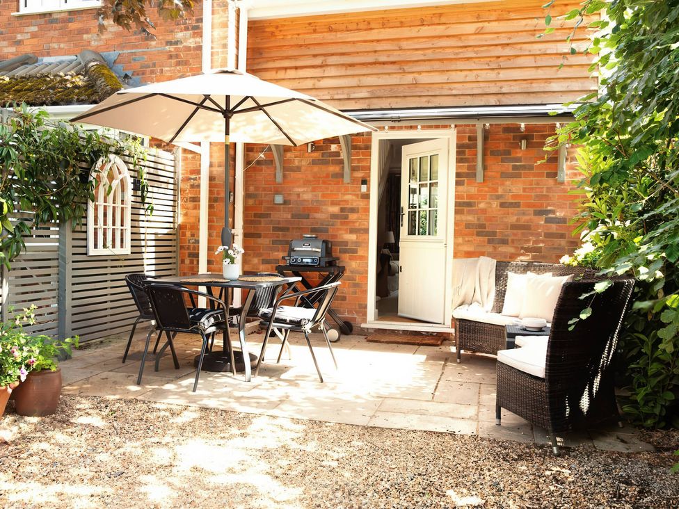 An outdoor patio with a table and chairs at TBC