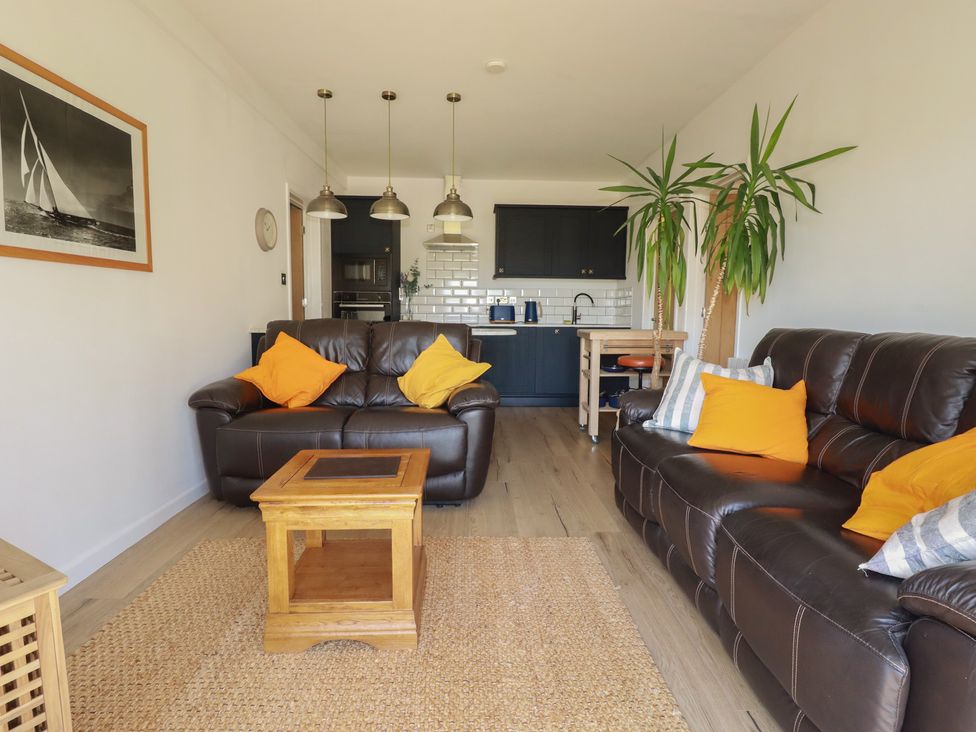 A living room with a sofa and coffee table at Rollies Retreat in Fowey