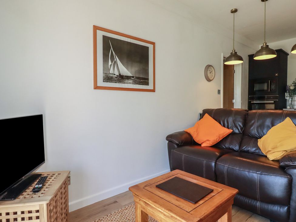 A living room with a sofa and coffee table at Rollies Retreat in Fowey