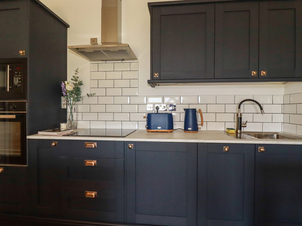 A kitchen with a sink and kettle at Rollies Retreat in Fowey