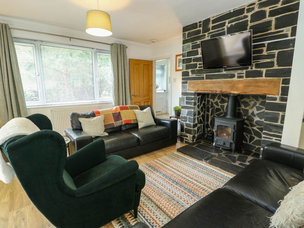 A living room with a sofa and armchair in Dyffryn, Betws-Y-Coed