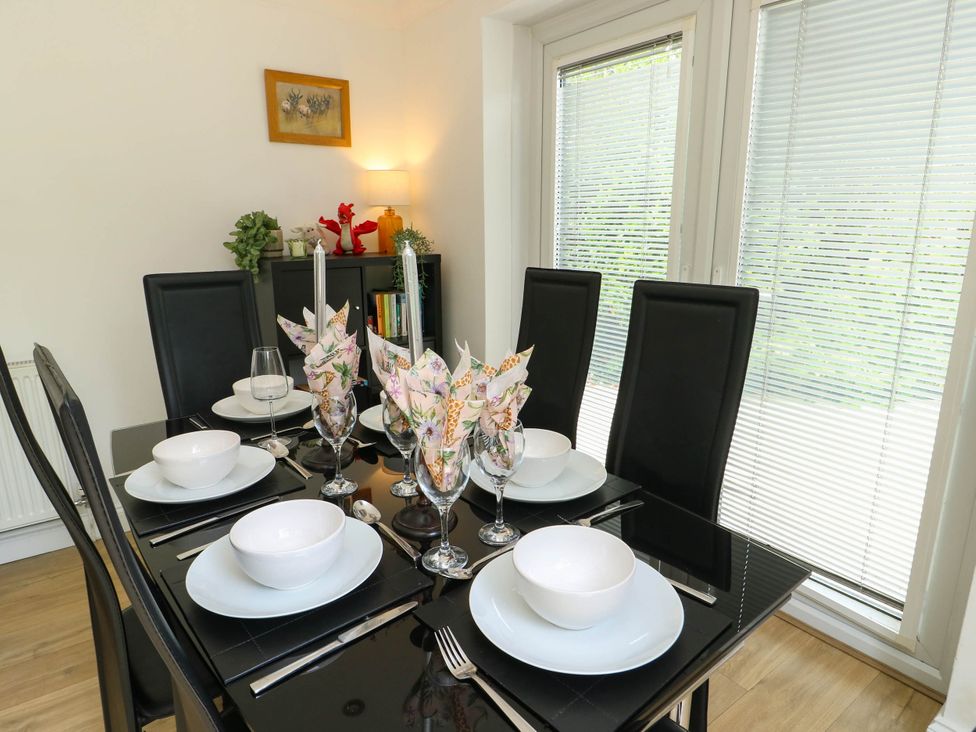 A dining room with a table set for meals at Dyffryn in Betws-Y-Coed