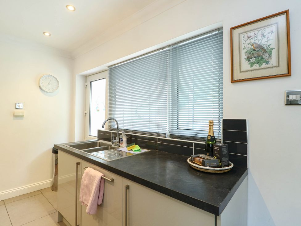 A kitchen with a sink and window at Dyffryn in Betws-Y-Coed