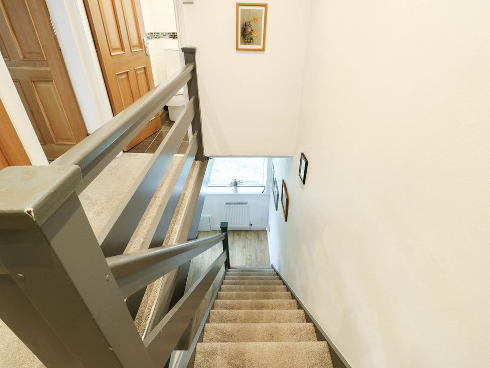 A staircase with railing and doors at Dyffryn in Betws-Y-Coed
