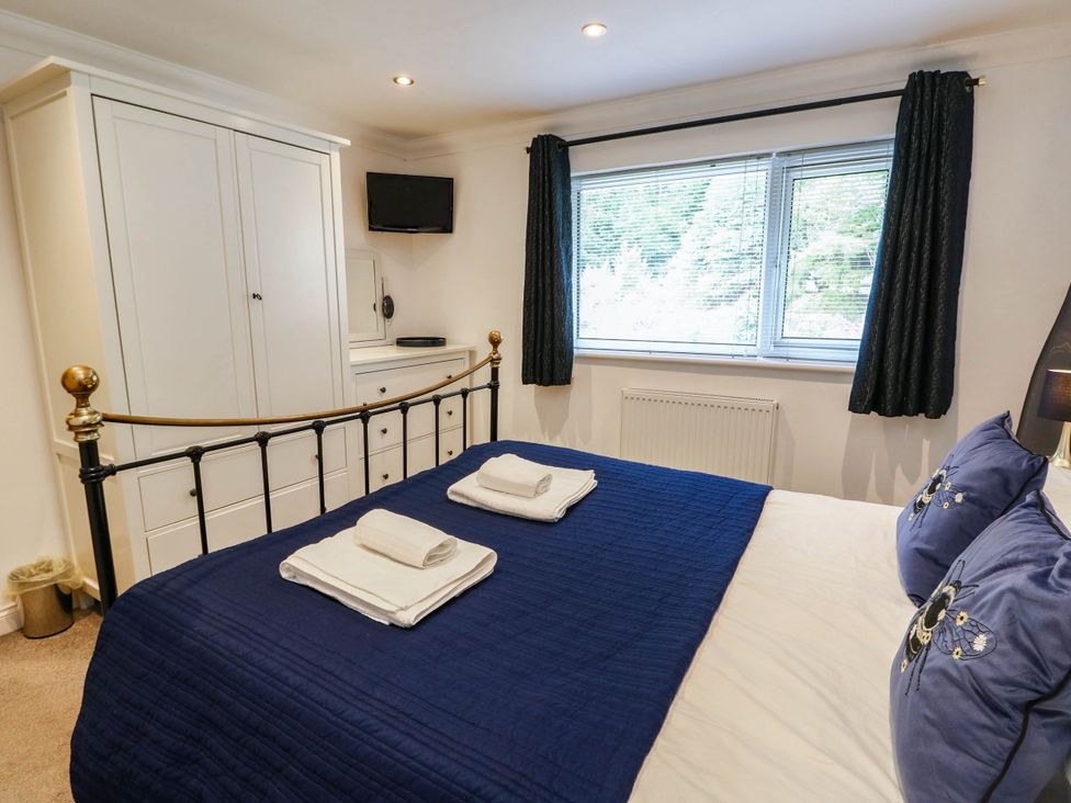 A bedroom with a bed and television at Dyffryn in Betws-Y-Coed