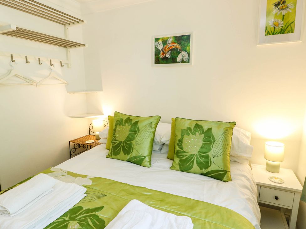 A bedroom with a bed and decorative pillows at Dyffryn in Betws-Y-Coed