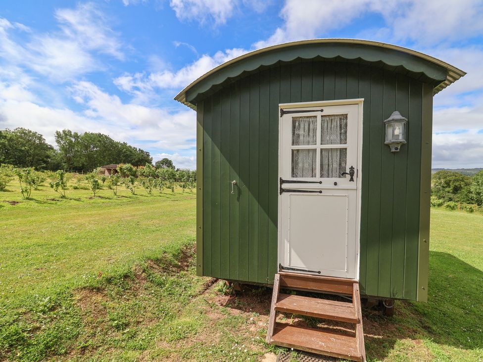 A shepherd's hut with steps and a door at Shepherds Hut at East Hill Pride Four Elms Hill Nr. Sidmouth