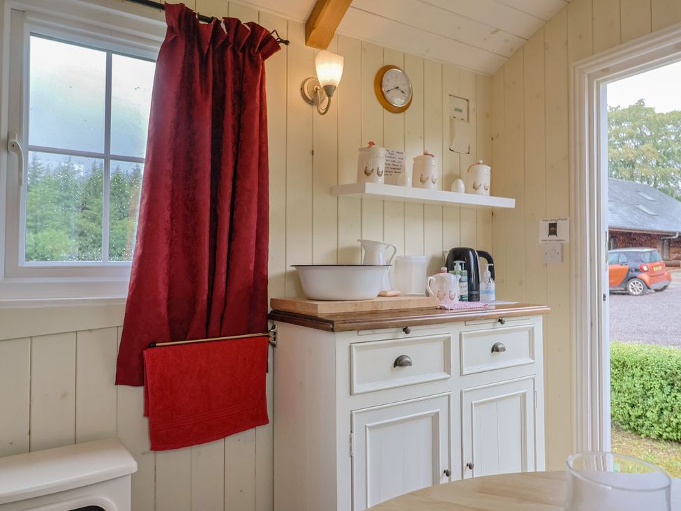 A kitchen space with a cabinet and kettle at Shepherds Hut at East Hill Pride in Four Elms Hill Nr. Sidmouth