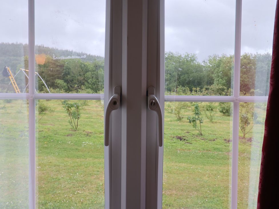 A window with a handle and grass outside at Shepherds Hut at East Hill Pride Four Elms Hill Nr. Sidmouth