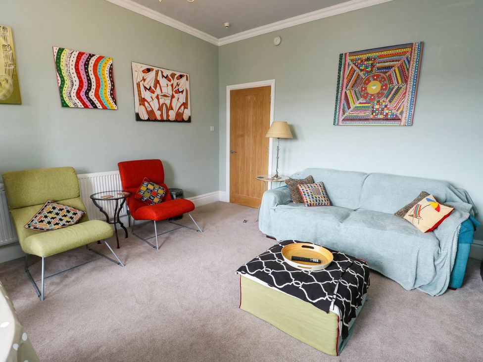 A living room with a sofa and armchairs at Flat 3 in Llandudno