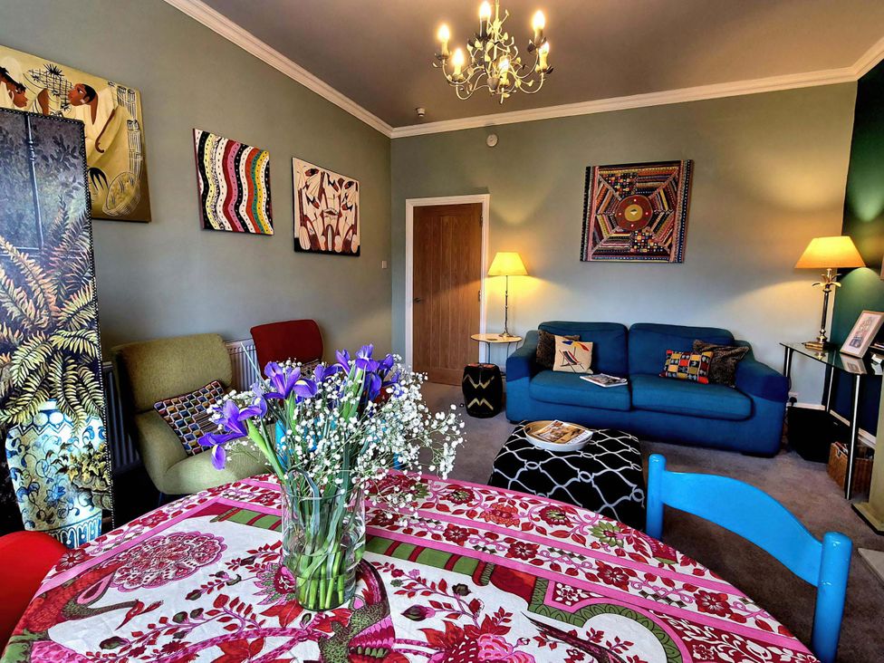 A living room with artworks and furniture at Flat 3 in Llandudno