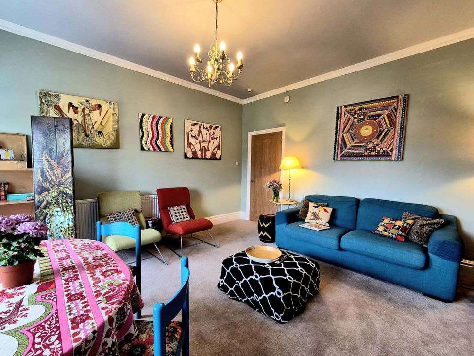 A living room with a sofa and table at Flat 3 in Llandudno