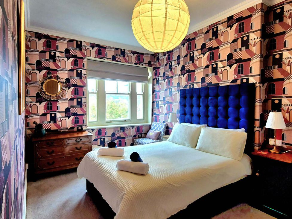 A bedroom with a bed and a window at Flat 3 in Llandudno