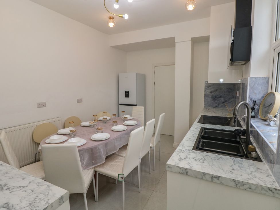 A kitchen with a table set for dining at 5 Gelli Terrace in Caerphilly