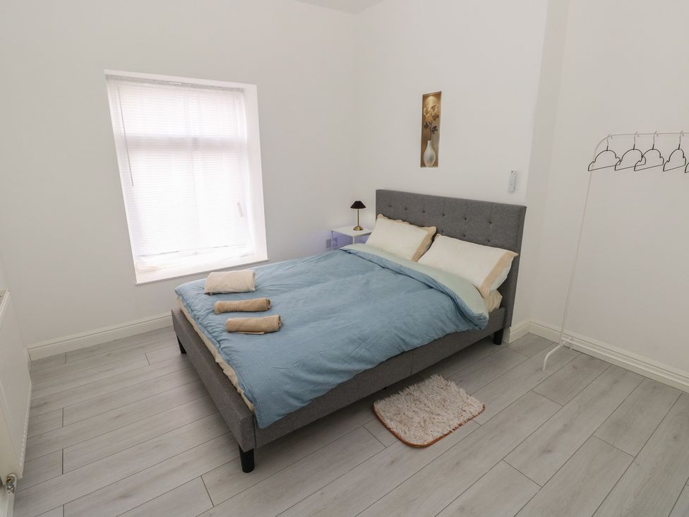 A bedroom with a bed and nightstand at 5 Gelli Terrace Caerphilly