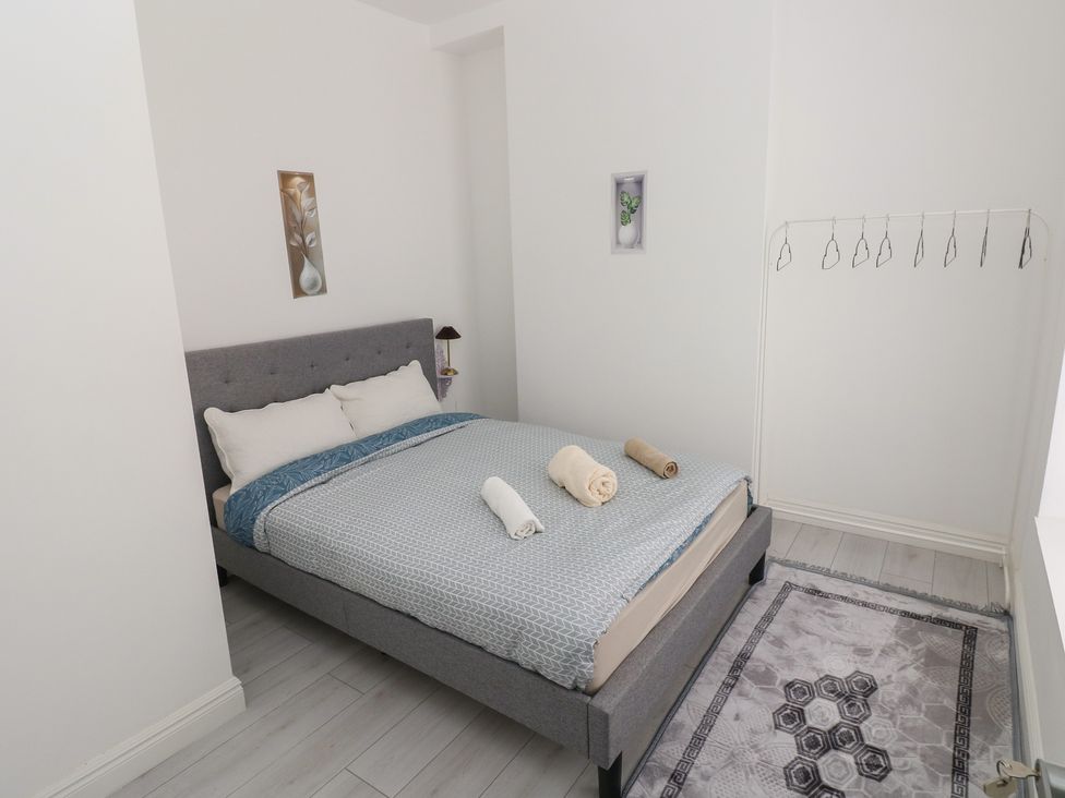 A bedroom with a bed and decorative items at 5 Gelli Terrace Caerphilly