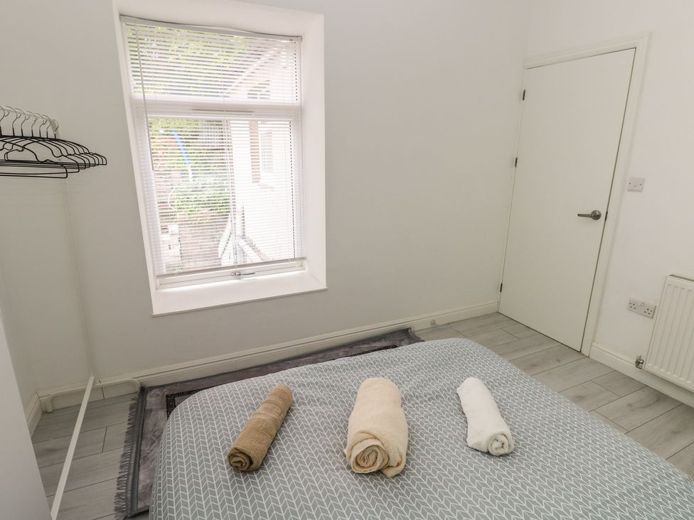 A bedroom with towels on a bed at 5 Gelli Terrace Caerphilly