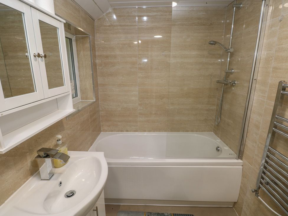 A bathroom with a bathtub and shower at 5 Gelli Terrace in Caerphilly