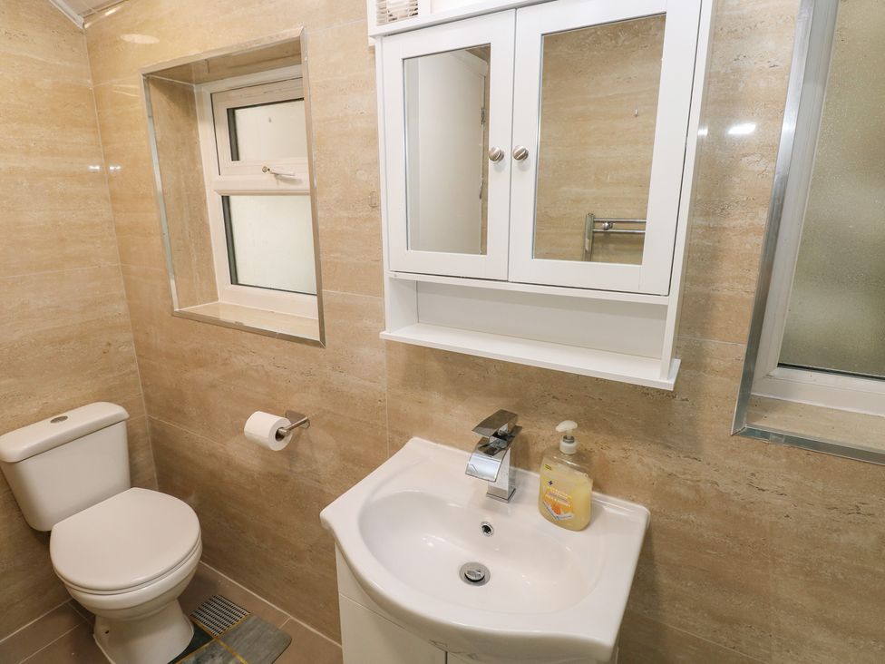 A bathroom with a toilet and sink at 5 Gelli Terrace in Caerphilly