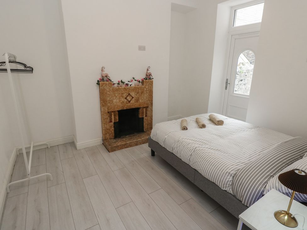 A bedroom with a bed and towels on it at 5 Gelli Terrace in Caerphilly