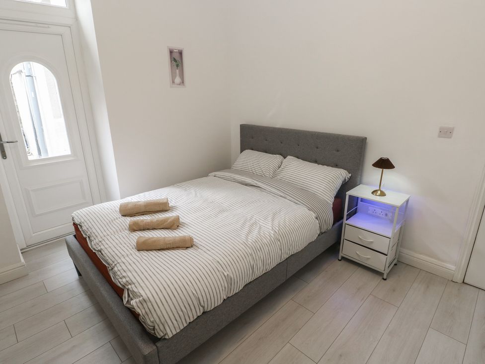 A bedroom with a bed and bedside table at 5 Gelli Terrace in Caerphilly
