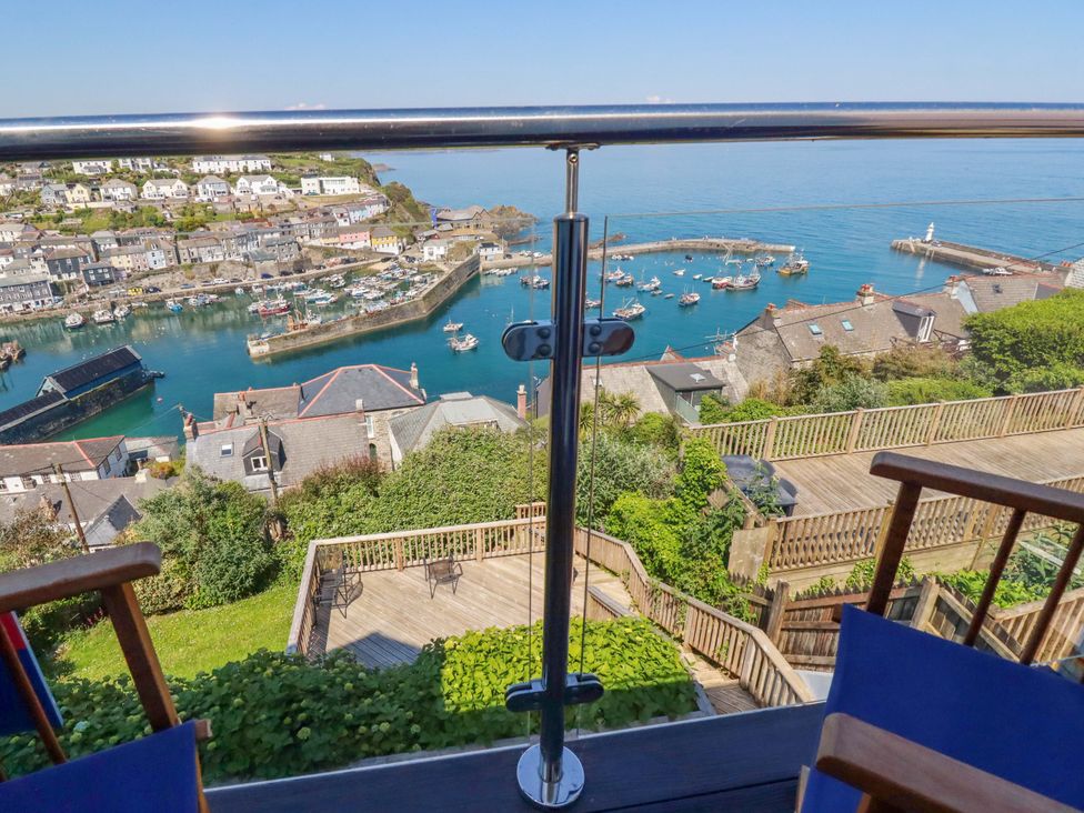 A view of a harbor with boats and wooden decking at Trewollock in Mevagissey