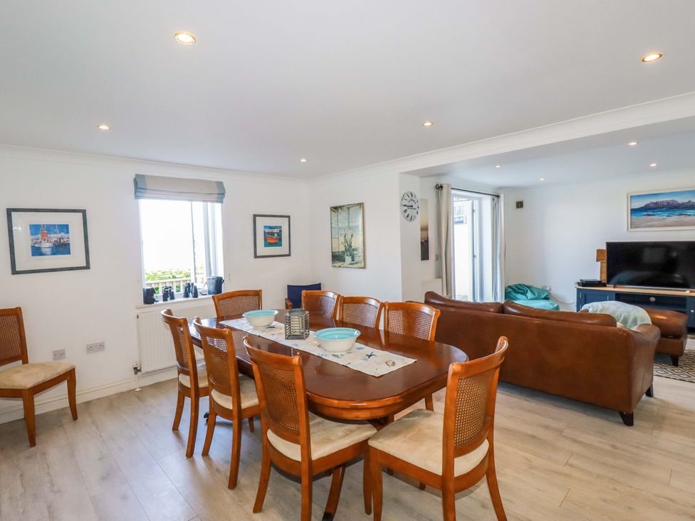 A dining room with a table and chairs at Trewollock in Mevagissey
