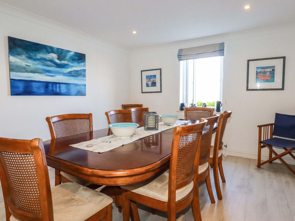 A dining room with a table and chairs at Trewollock in Mevagissey
