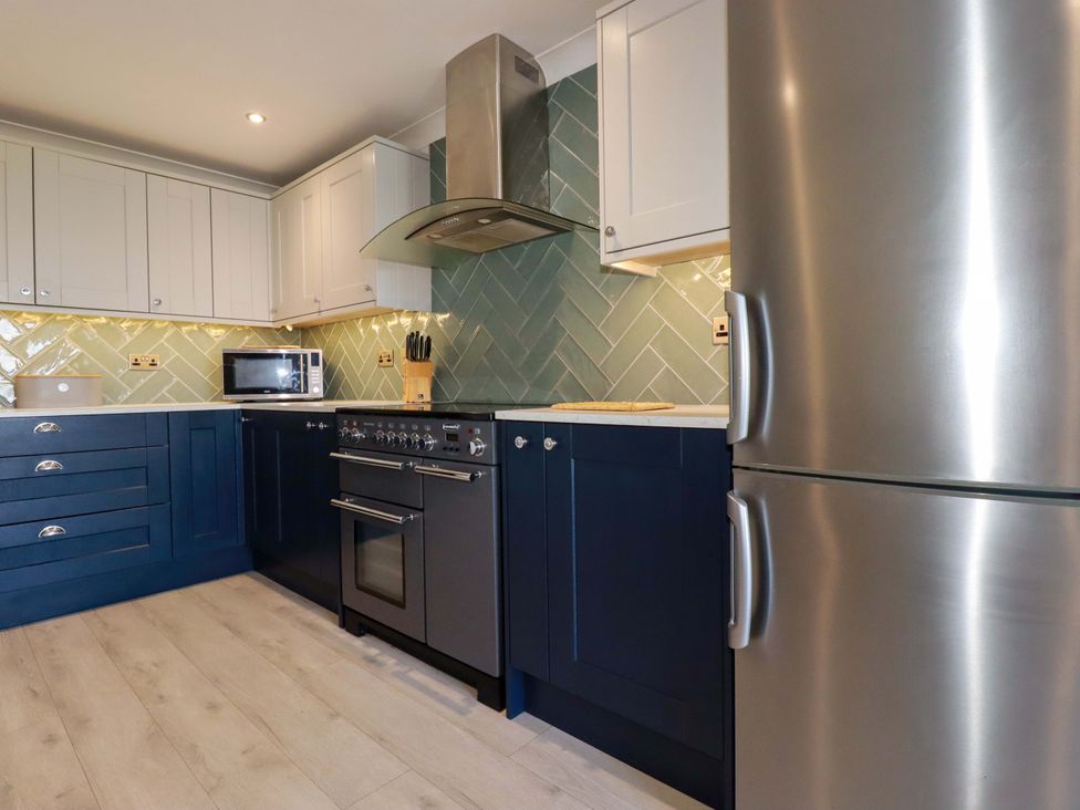 A kitchen with appliances and cabinets at Trewollock in Mevagissey