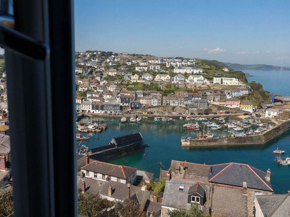 View of a harbor with boats and houses at Trewollock in Mevagissey