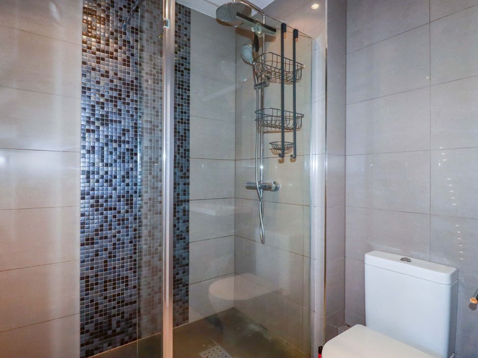 A bathroom with a shower and toilet at Trewollock in Mevagissey