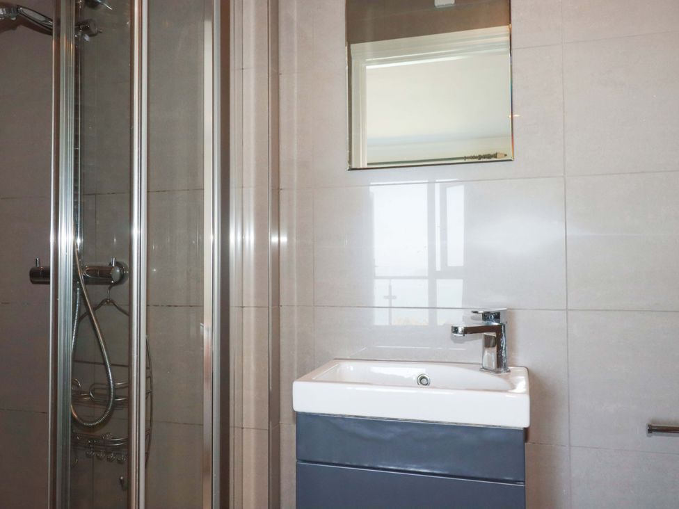 A bathroom with a shower and sink at Trewollock in Mevagissey