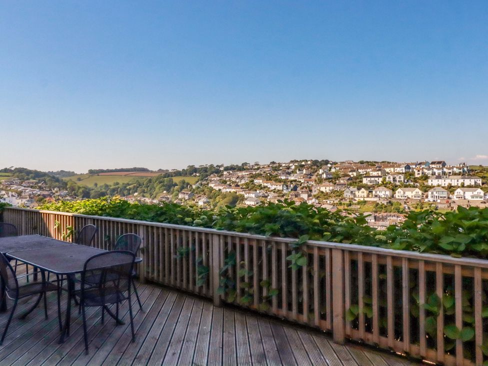 An outdoor area with a table and chairs at Trewollock in Mevagissey