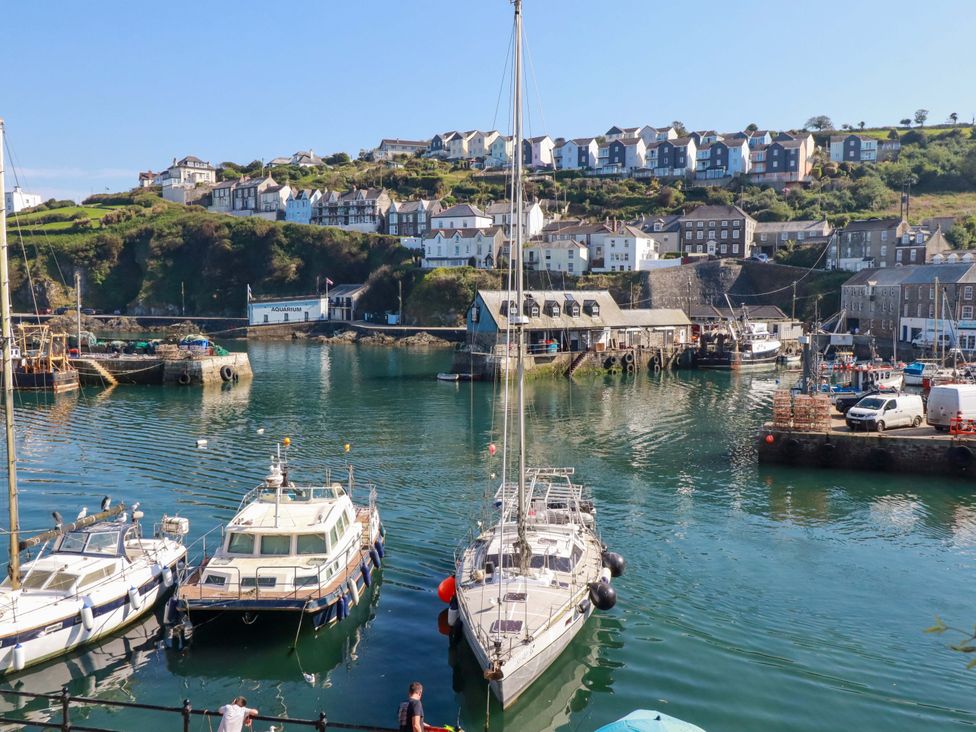 A scenic view of a harbor with boats and houses at Trewollock in Mevagissey